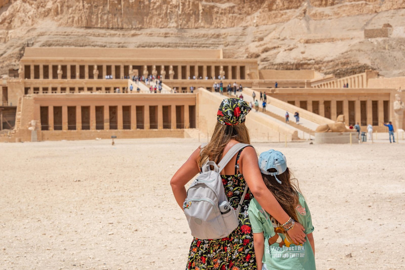 A woman and child explore the historic Temple of Hatshepsut in Egypt.